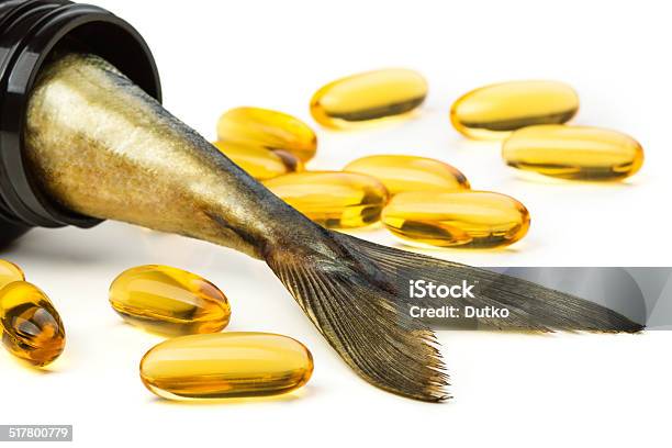 Fish Oil Capsules And Fish Tail In Brown Jar Stock Photo - Download Image Now - Cooking Oil, Omega-3, Salmon - Seafood