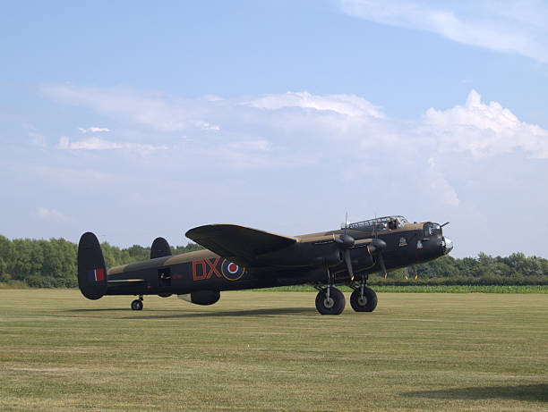 istock Lancaster Bomber on a grass airfield 517801137