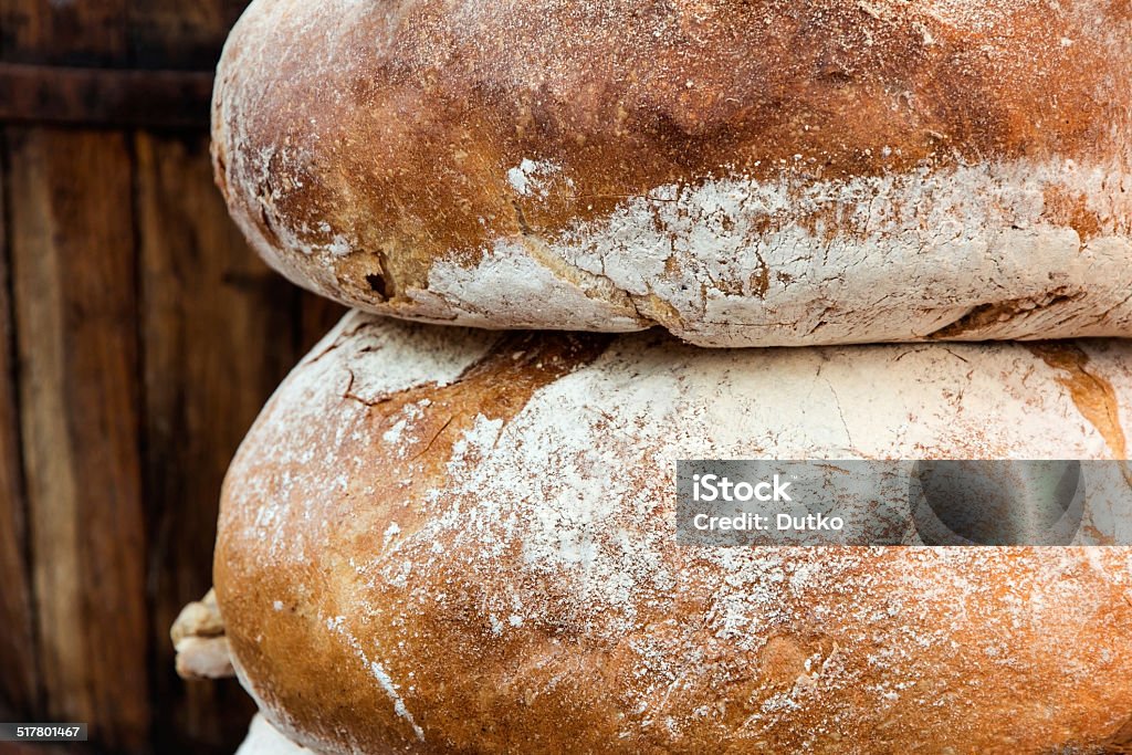 Couple loafs of  bread lying near barrel Couple loafs of rye bread lying near barrel Abundance Stock Photo