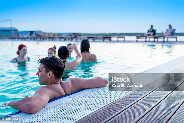 Relaxing In A Pool On Summer Vacation Stock Photo - Download Image Now - Pool Party, Deck Chair, Dusk