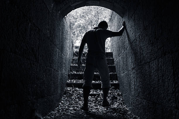 istock Young tired man leaves dark stone tunnel 517802450