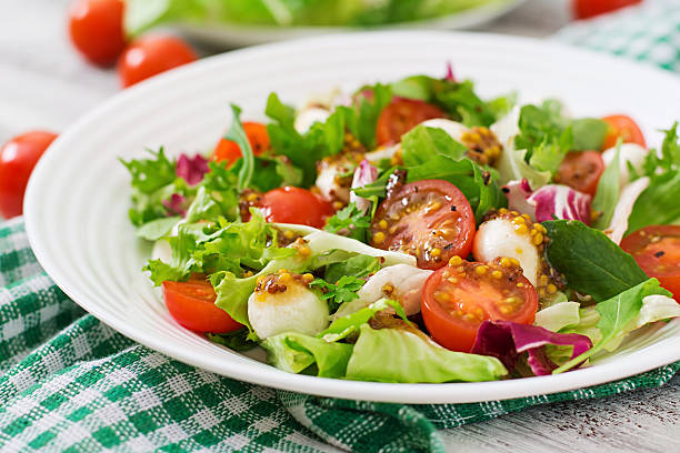 istock Dietary salad with tomatoes, mozzarella and lettuce 517802736