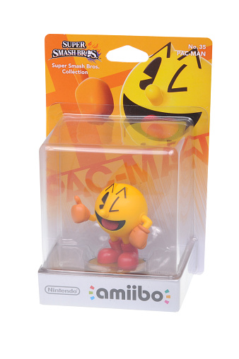 Adelaide, Australia - February 23, 2016: A studio shot of a Pac-Man Nintendo Amiibo Figurine.. This figurine is part of series released by Nintendo where placing the figure on the interface allows players to control that character in the game.