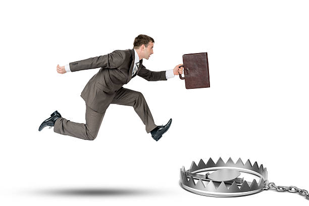 istock Running businessman with bear trap 517804284