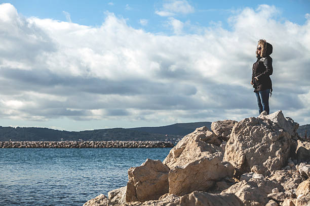 istock Women standing on the rocks 517804536