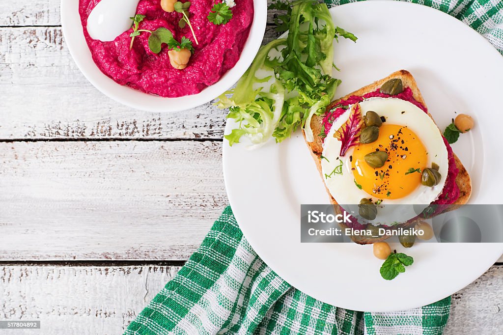 Diet sandwiches with beet root hummus, capers and egg 7-Grain Bread Stock Photo