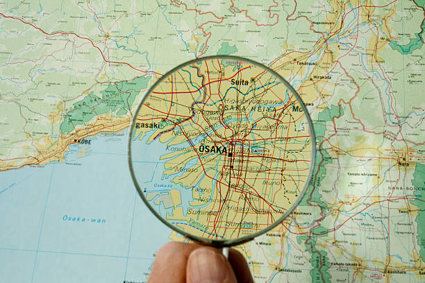 Conceptual image of a hand holding a magnifying glass over an world globe