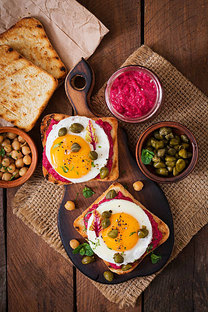 istock Diet sandwiches with beet root hummus, capers and egg 517805468