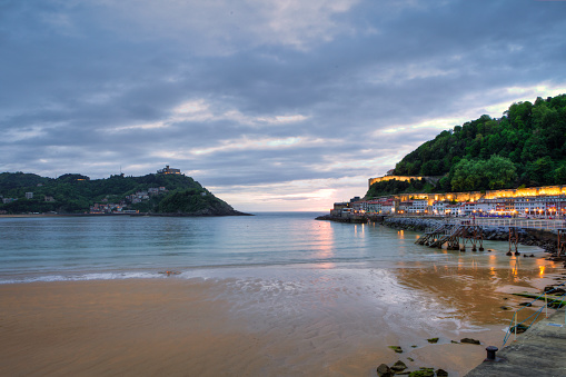 San Sebastian bay and old  fishing port at sunset. Mont Igueldo in the background.