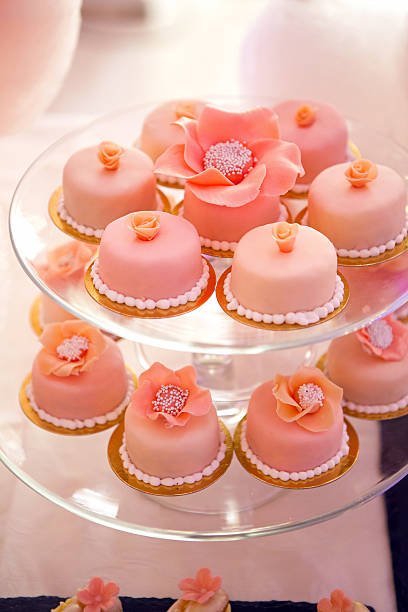 istock pink cupcakes on a glass stand 517807648
