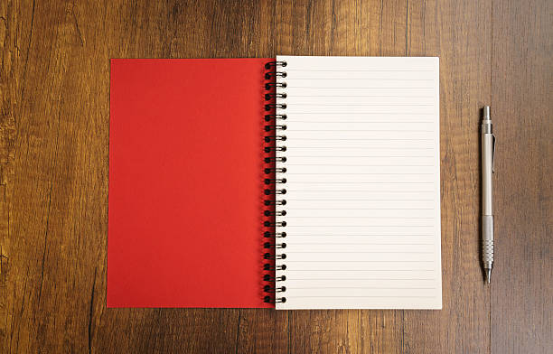 istock Note book with pencil on a wooden desk 517807662