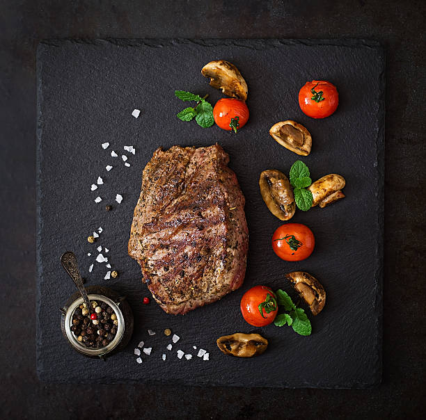istock Juicy steak medium rare beef with spices and grilled vegetables. 517807854