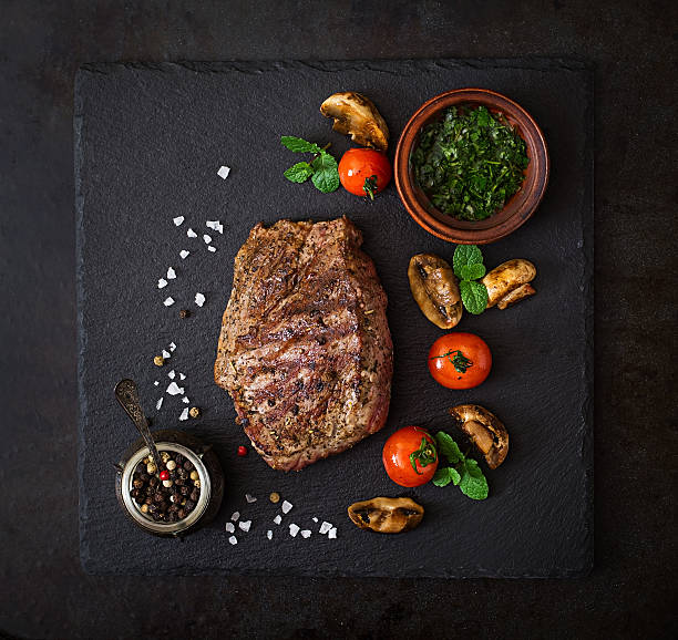 Juicy steak medium rare beef with spices and grilled vegetables.