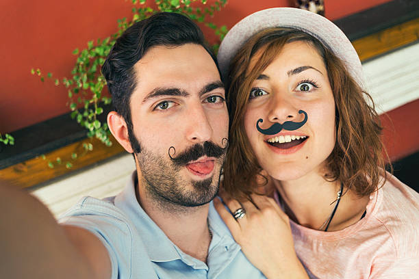 istock Couple making selfie with mustaches 517807972