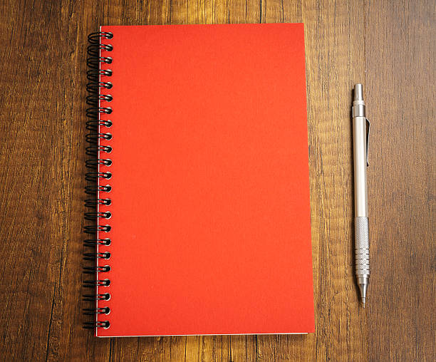 istock Note book with pencil on a wooden desk 517808468
