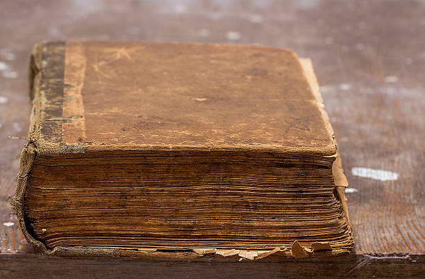 istock Old book on a wooden table 517808724