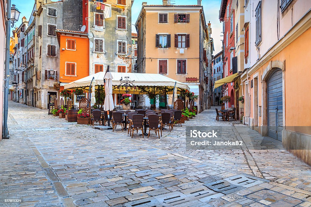 Medieval Croatian old street,with street cafe in Rovinj,Europe Spectacular stone paved street with colorful houses and typical street cafe bar, Rovinj old town,Istria region,Croatia,Europe Rovinj Stock Photo