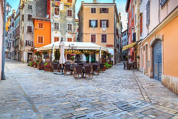 Spectacular stone paved street with colorful houses and typical street cafe bar, Rovinj old town,Istria region,Croatia,Europe