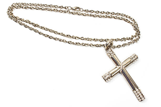 istock Silver christian cross necklace isolated on white 517812519