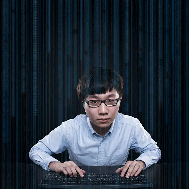 Photo of asian hacker intrude online data