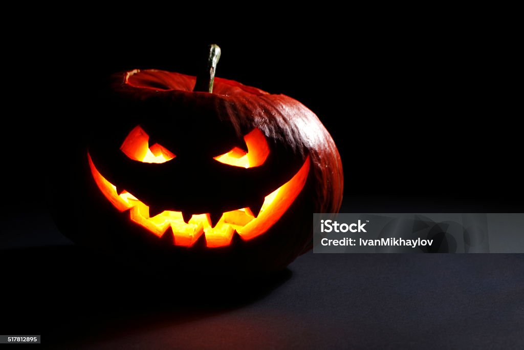 Halloween pumpkin head Halloween pumpkin head jack lantern with scary evil face on black Black Color Stock Photo
