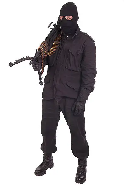 mercenary in black uniforms with machine gun