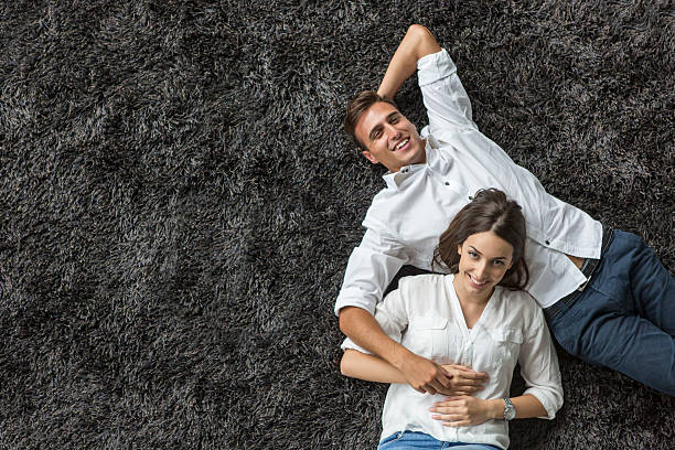 istock Young couple relaxing on the carpet 517815805