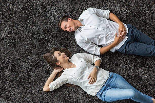 istock Young couple relaxing on the carpet 517815807