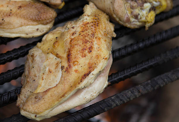 Free range heritage chicken cooking over a campfire.