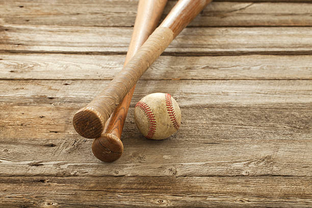 istock Old baseball and bats on rough wood surface 517816145