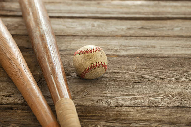 istock Old baseball and bats on rough wood surface 517816147