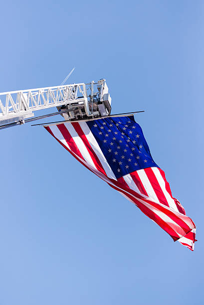 istock Fire truck ladded extended with an American Flag 517816319