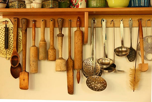 istock Wooden and metal kitchen ware hanging on the wall. 517818675