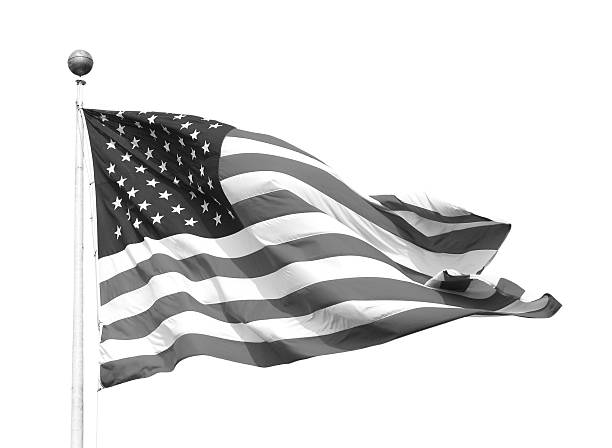 Abstract photograph of an American flag waving in the breeze very closeup. High contrast black and white. Stars and stripes visible. No people in photograph. Room for your content message at top of image. Horizontal composition.