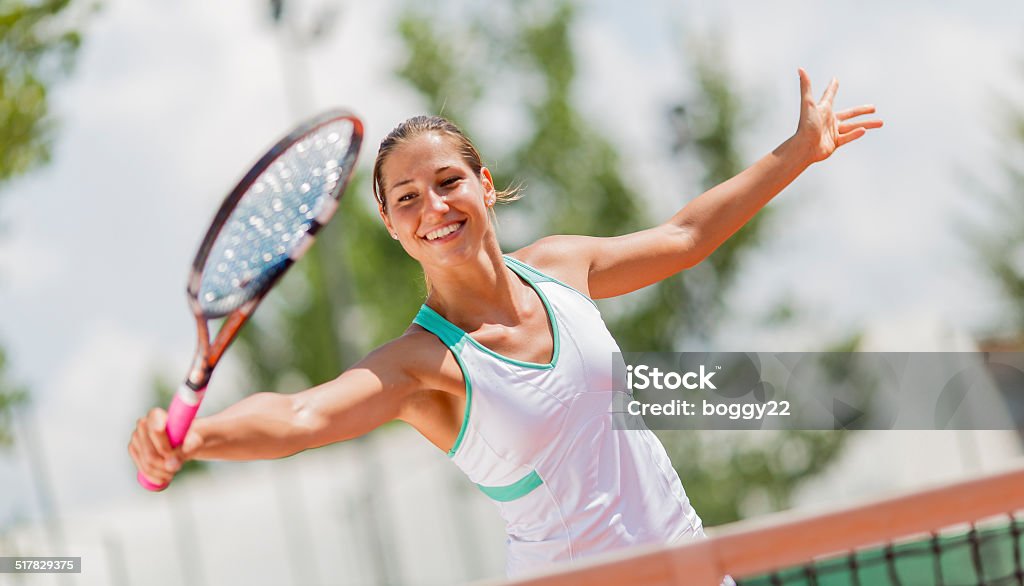 Young woman playing tennis Activity Stock Photo