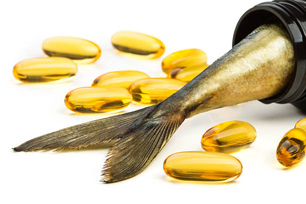 istock Fish oil capsules and fish tail in brown jar 517829507