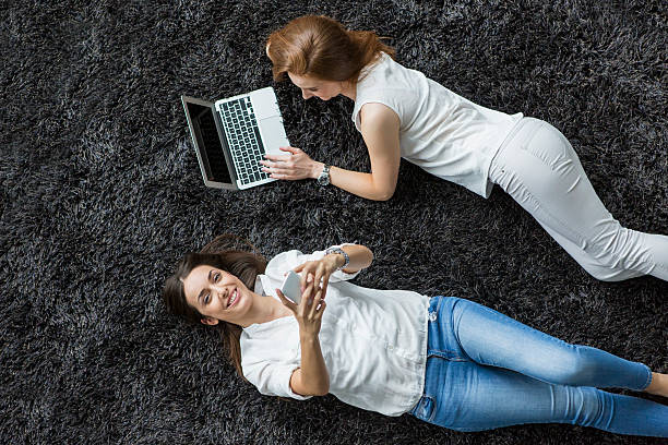 istock Young women relaxing on the carpet 517829885