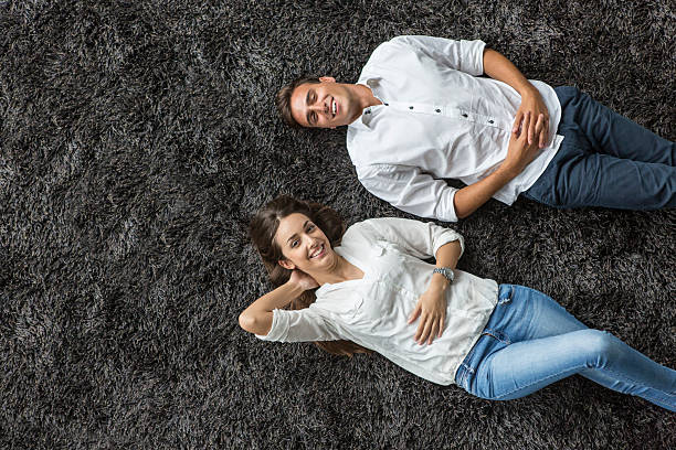 istock Young couple relaxing on the carpet 517829887