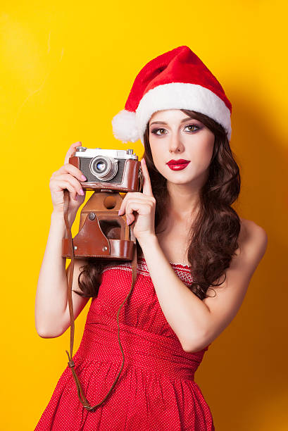 istock girl in christmas hat with camera 517831443