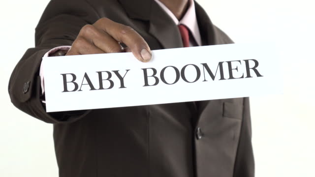 Businessman holding white card with Baby Boomer, Gen X, Gen Y, Gen Z sign