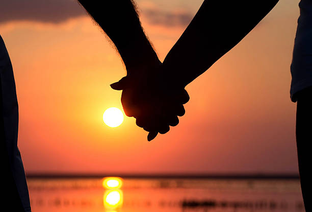 istock couple at sunset holding hands 517839226