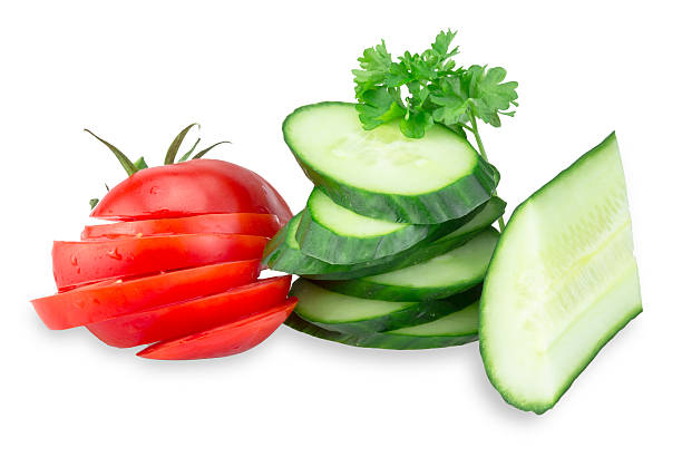 istock Cucumber and Tomato slices isolated on white 517841968