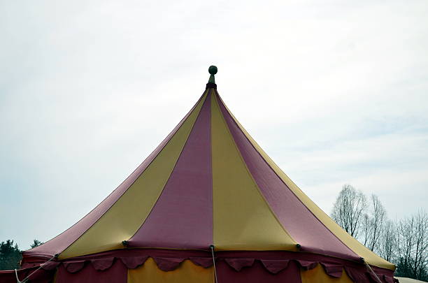 istock top of a medieval circus tent colorful with blue sky 517844146