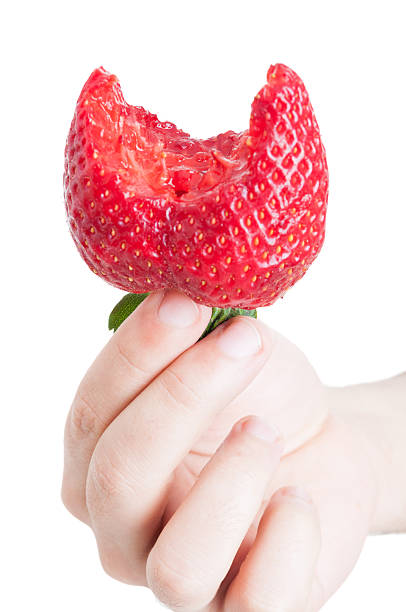 istock Bitten delicious strawberry in hand of a man 517844152