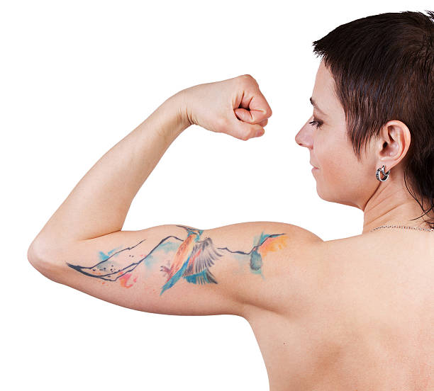 istock Woman with a tattoo showing biceps 517847874