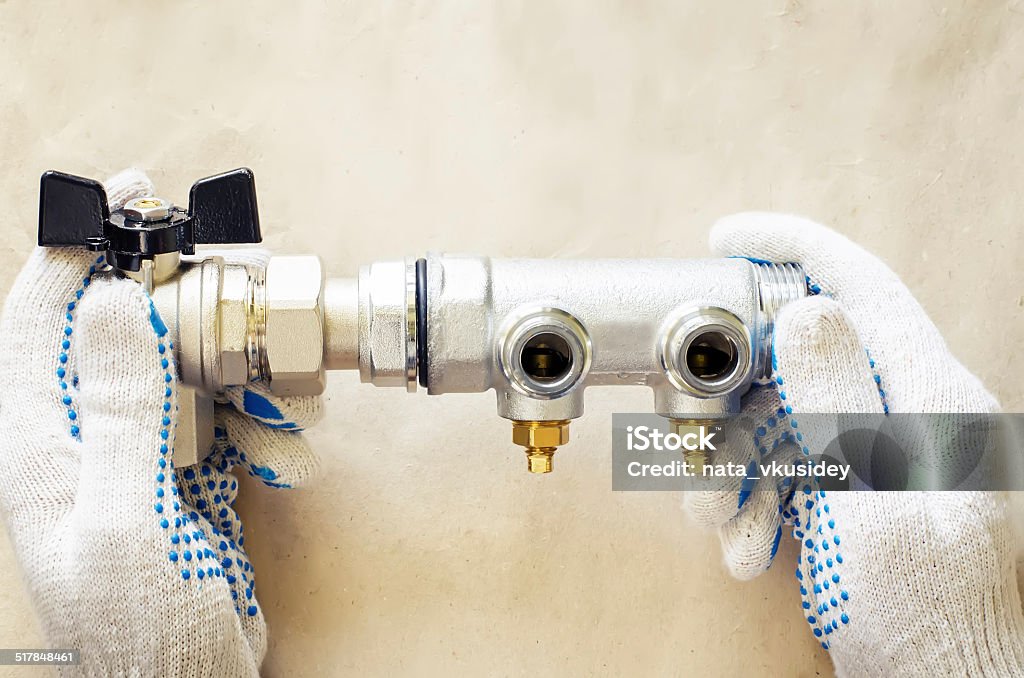 plumber at work with tools plumbing plumber at work with tools plumbing on a light woody background. tinting. selective focus Adjustable Wrench Stock Photo