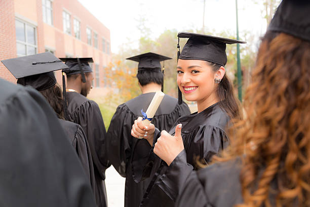 istock Education: Female graduate and friends on college campus. 517848808
