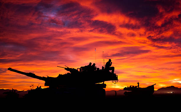 MIA1 Abrams Tank at Sunset A silhouette of a U.S. Marine Corps M1A1 Abrams Tank Crew with the 1st Tanks Bravo Company 3rd Battalion 4 Marine Regiment  at Twentynine Palms Marine Corps Base, California 23 Jan, 2013. DoD Photo armored tank photos stock pictures, royalty-free photos & images