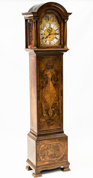 an antique grandfather clock in studio on white background
