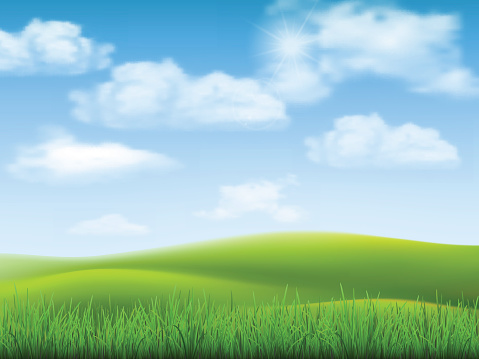 Nature landscape with sky, hills and grass on foreground.